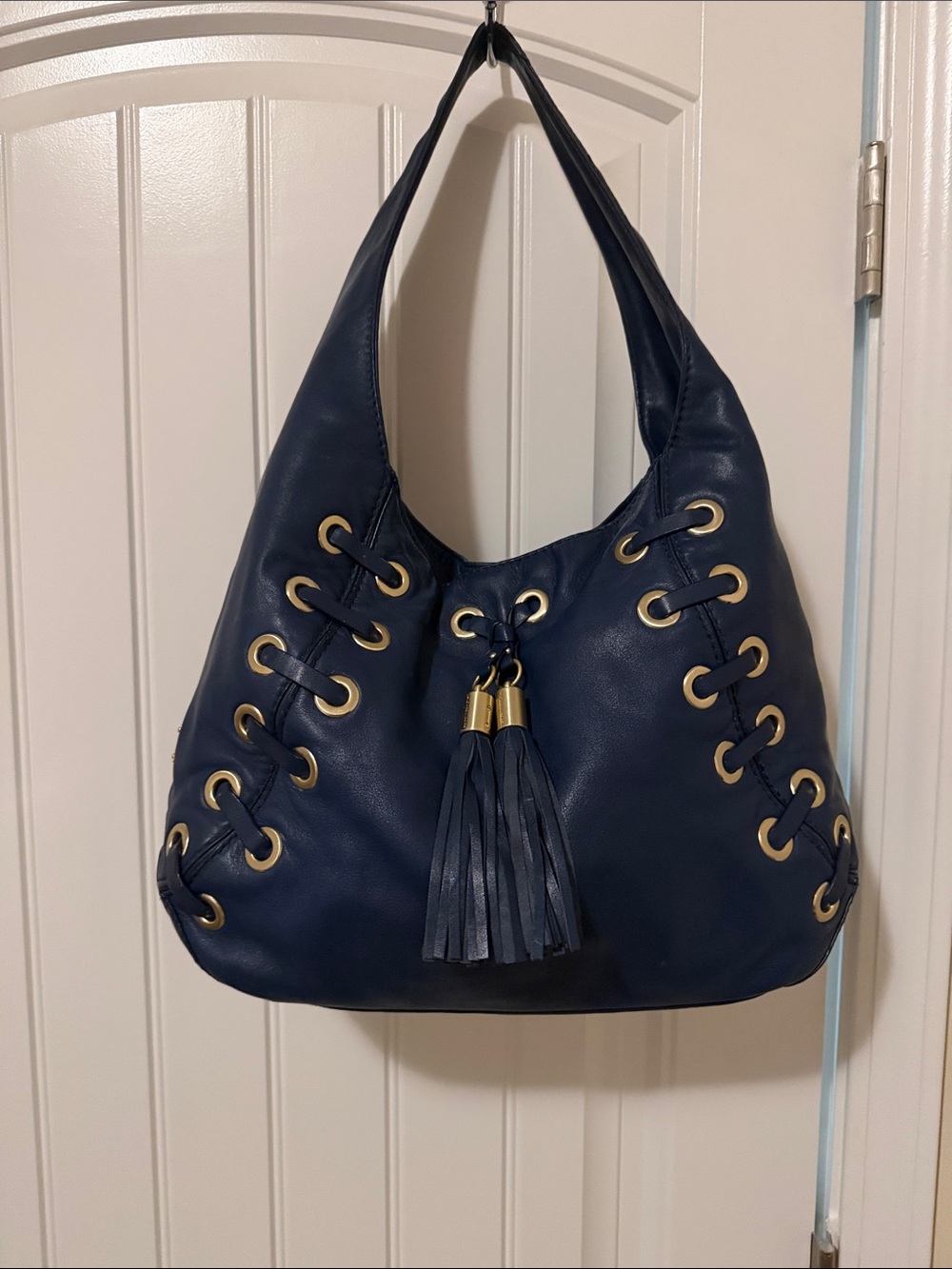 Michael Kors Navy Hobo Bag with Tassel and Gold Eyelets